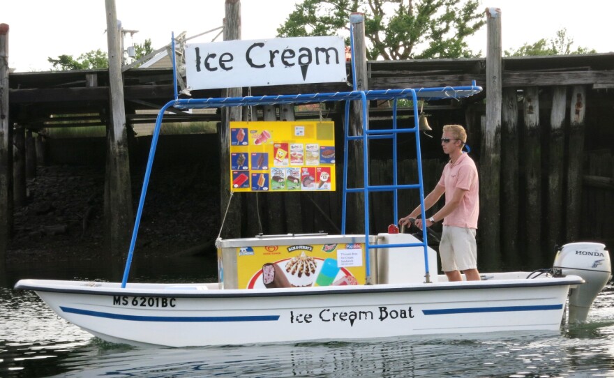 Captain Tim Titcomb maneuvers his 15-foot Carolina skiff along the sandy beaches of Sampson's Island, Mass., in July 2014.