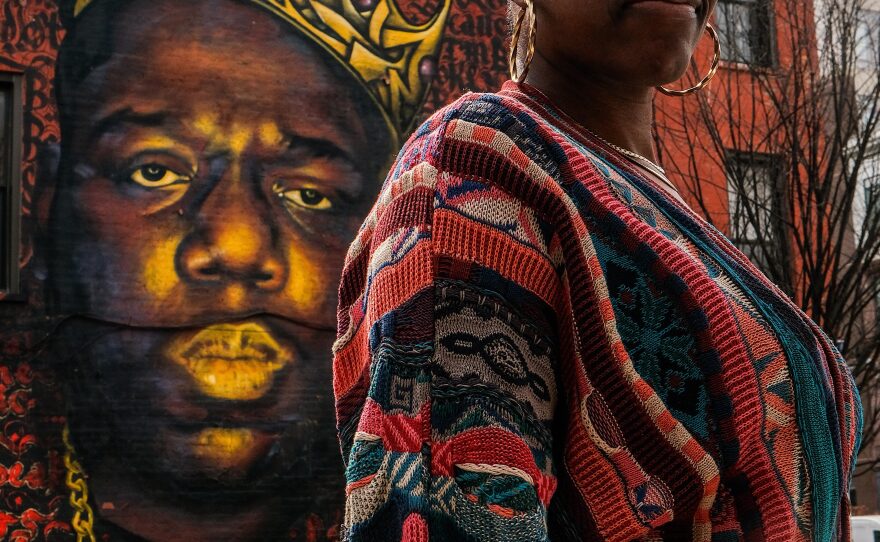 Syreeta Gates, an author and Hip-Hop archivist, in front of mural of Notorious BIG on Quincy Street. She says his songs epitomize the art of Black music storytelling.