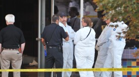 Investigators are on the scene at the Century 16 movie theatre where a gunmen attacked movie goers during an early morning screening of the new Batman movie, 'The Dark Knight Rises' July 20, 2012 in Aurora, Colorado.
