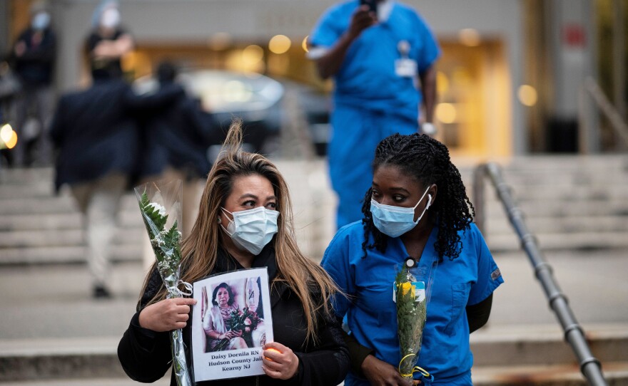 Nurses and health care workers mourn colleagues who died during the pandemic at a demonstration in April outside Mount Sinai Hospital in Manhattan.