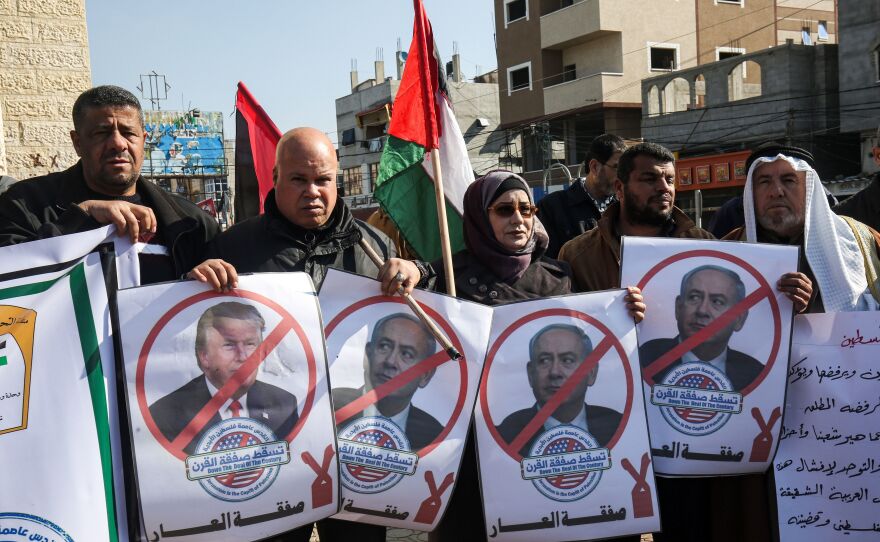 Palestinian demonstrators in Rafah, in the southern Gaza strip, hold portraits of President Trump and Israeli Prime Minister Benjamin Netanyahu during a protest against Trump's announcement of a peace plan on Tuesday.