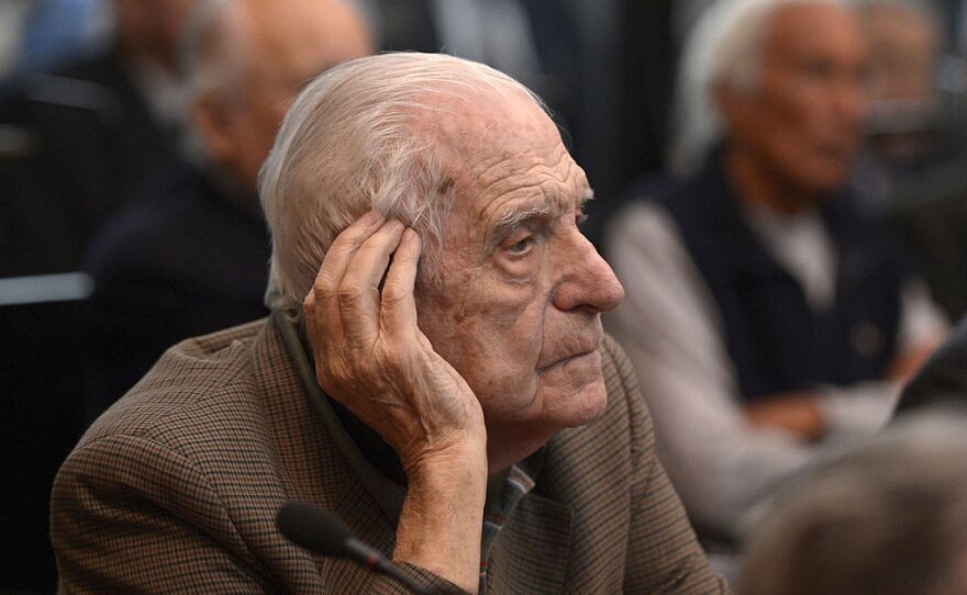 Former general and member of the military junta, Reynaldo Bignone, gestures during his trial to investigate the crimes committed during the Operation Condor in March 2013.