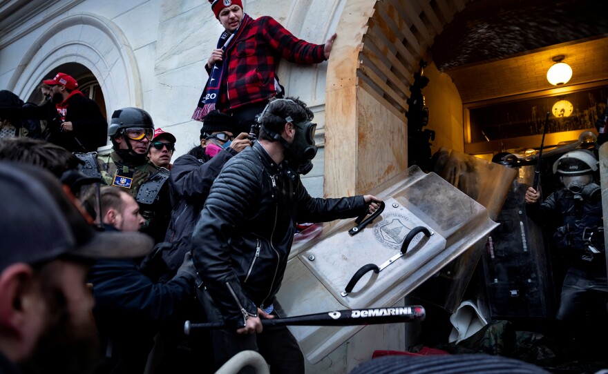 Rioters clash with police as they try to storm the U.S. Capitol. The Justice Department has created a kind of framework for prosecutions, dividing the Jan. 6 defendants into different categories based on what they are accused of doing that day.