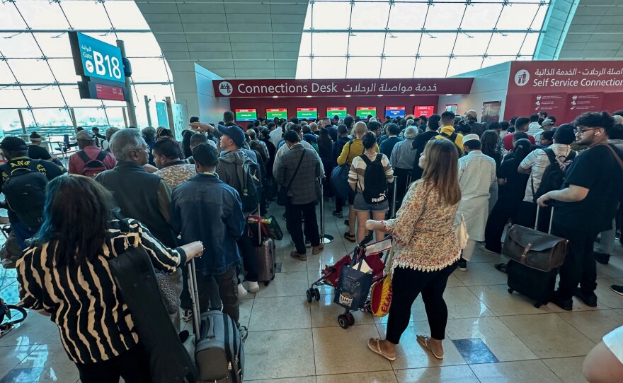 Passengers queue at a flight connection desk at the Dubai International Airport on Wednesday. Dubai's main airport diverted scores of incoming flights on Tuesday as heavy rains lashed the United Arab Emirates, causing widespread flooding around the country.