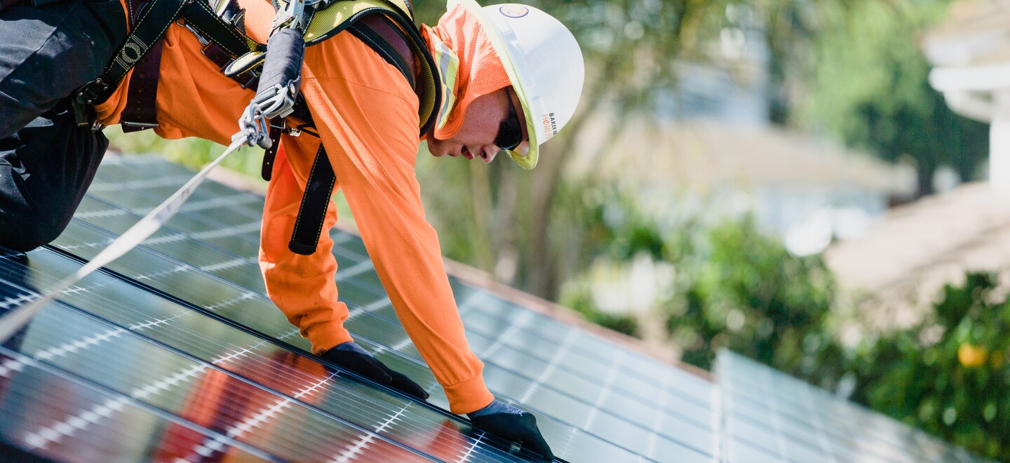 A worker installs rooftop solar panels in this undated photo.