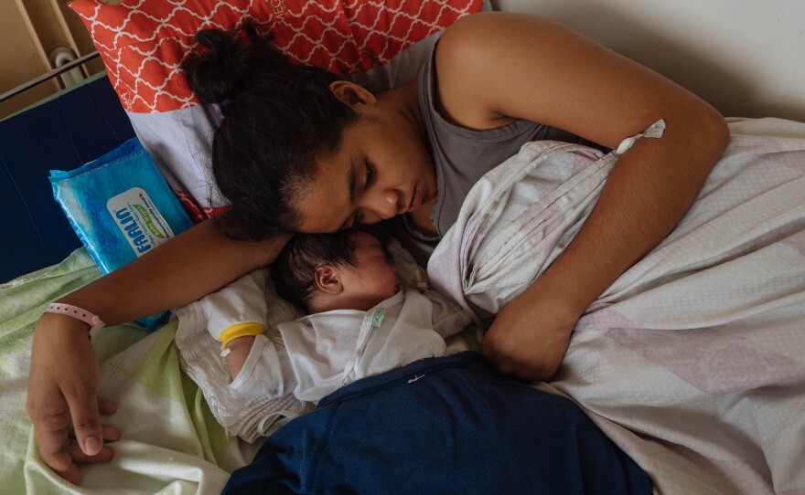 In November 2019, 18-year-old Ralyn Ramirez curls up with her second child, a boy. In between giving birth, she had warned other teens about having a baby.