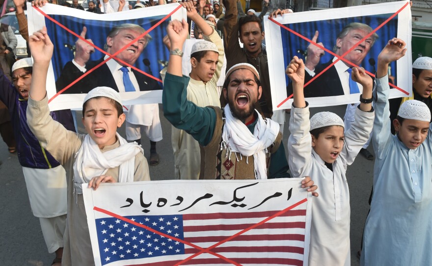 Demonstrators take part in a protest against U.S. aid cuts, in Lahore, Pakistan, on Friday.