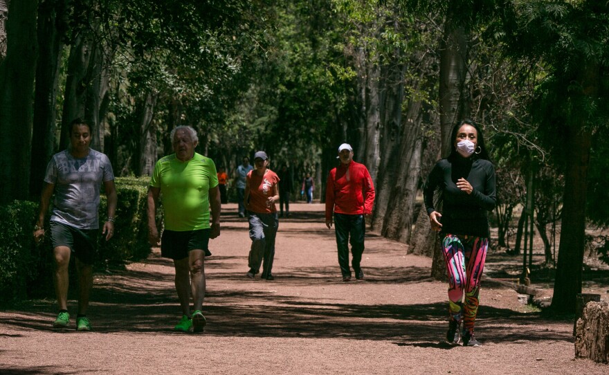 Runners in the wooded park of Viveros in Coyoacan, Mexico City. Mexico City has few runner-friendly spaces. The altitude discourages exertion and the air quality is often so bad some runners wear face masks. Yet health officials urge people to exercise more.