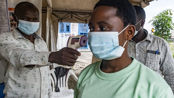 To keep Ebola from spreading in this current outbreak, a border health officer at the Busunga crossing between Uganda and the Democratic Republic of Congo checks a traveler's temperature using a contactless infrared thermometer on May 18.
