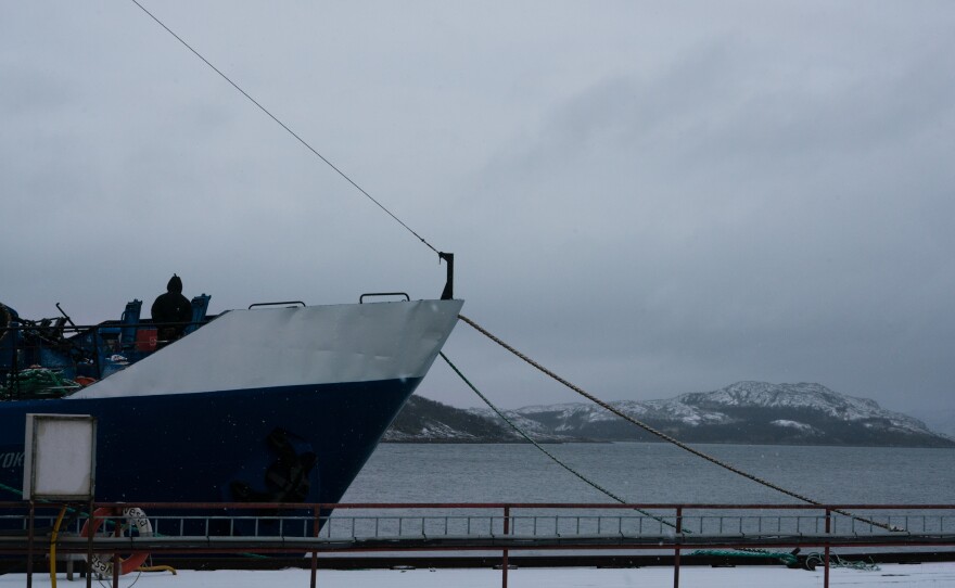 A view of a ship docked in the Kirkenes harbor.
