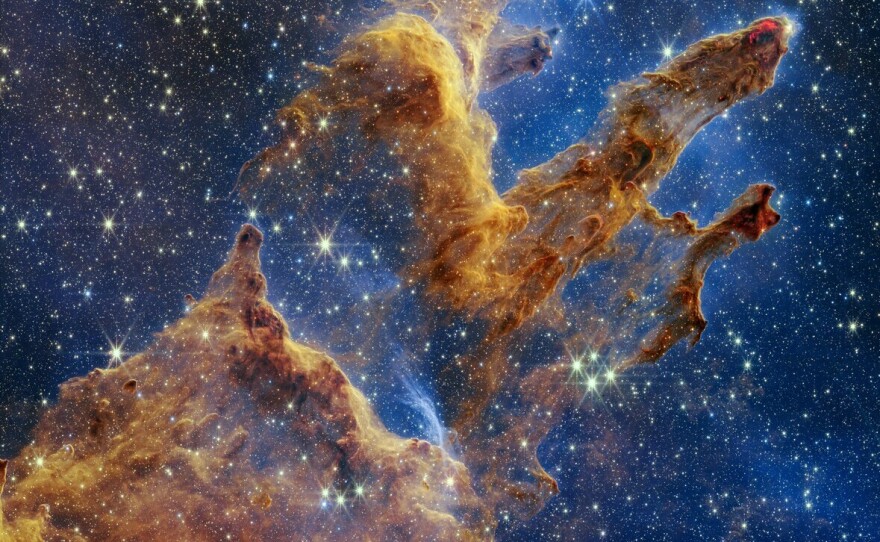 The Pillars of Creation were first photographed by Hubble in 1995. Webb's image reveals countless newly formed stars glistening amongst the columns of gas and dust.
