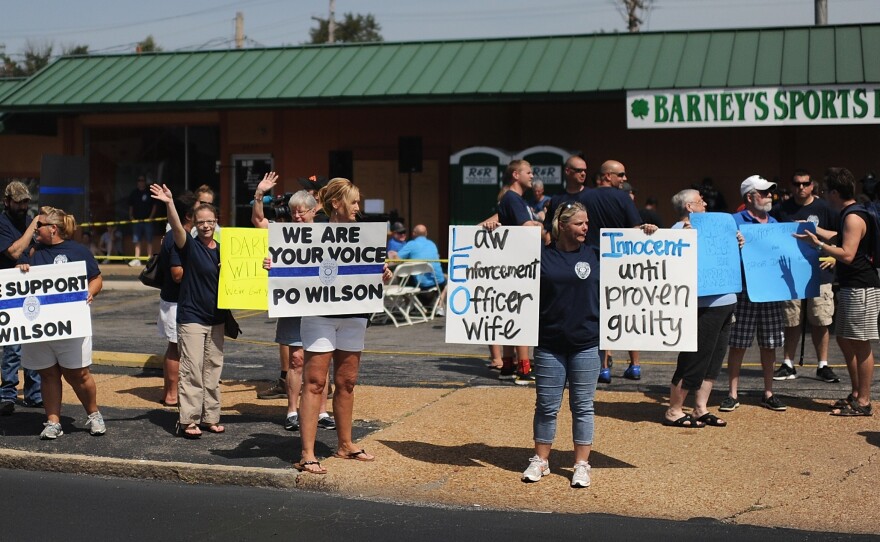 Protesters rally in support of Darren Wilson, the Ferguson police officer who shot Brown. Supporters have raised more than $400,000 for Wilson.