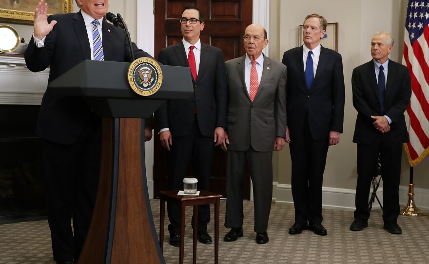 President Trump delivers remarks before signing tariff proclamations on steel and aluminum imports at the White House on March 8. Treasury Secretary Steven Mnuchin (second from left), Commerce Secretary Wilbur Ross, U.S. Trade Representative Robert Lighthizer and White House National Trade Council Director Peter Navarro look on.