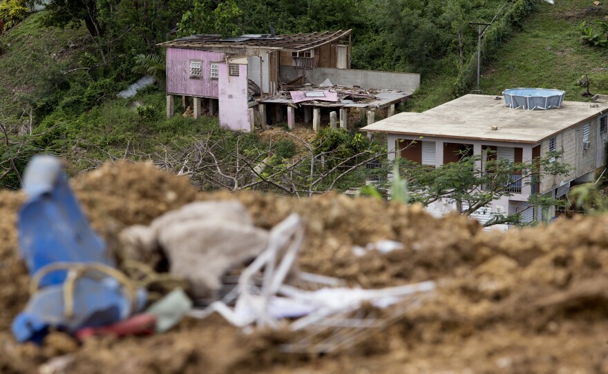 Homes damaged by Hurricane Maria in the Candelario neighborhood sit adjacent to the Toa Baja landfill.