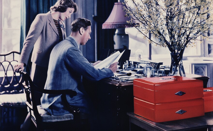 April 11, 1942: Princess Elizabeth talking to her father, King George VI whilst he goes through the Royal boxes in a study at Windsor Castle, Berkshire.