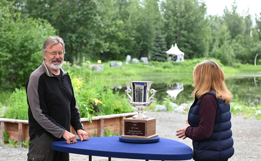 Leila Dunabr (right) appraises a 1990 Susan Butcher Iditarod trophy, in Anchorage, Alaska. ANTIQUES ROADSHOW “Alaska Native Heritage Center, Hour 1” premieres Monday, January 8 at 8/7C PM on PBS.