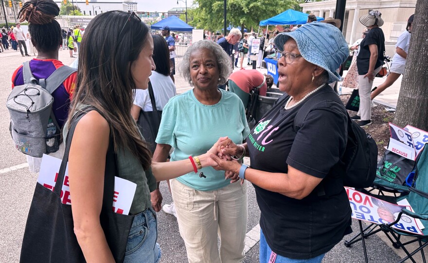 Bee Nguyen, left, talks to Carole Burton, center, and Tondalaire Ashford at a voting rights rally Saturday, May 16, 2026, in Montgomery, Ala.