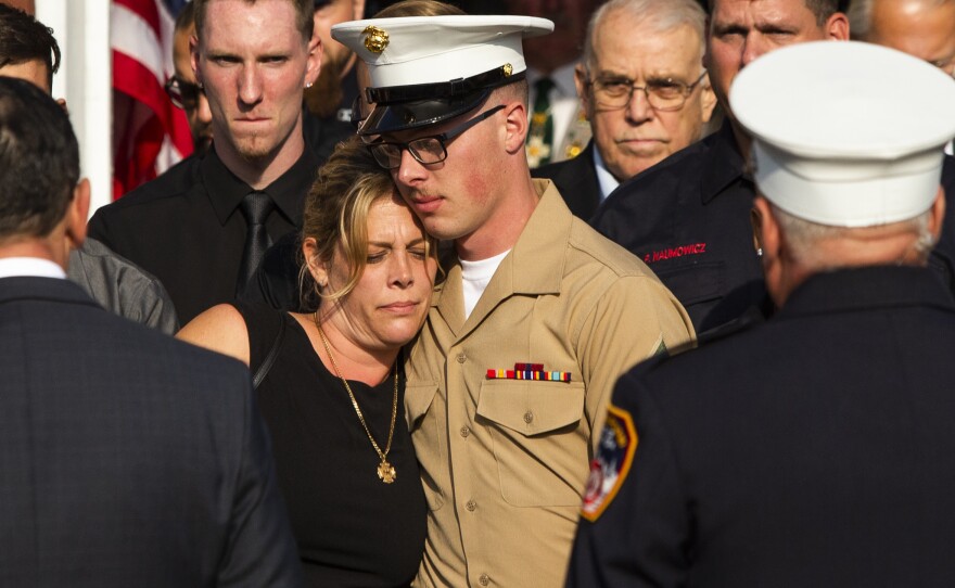 Erika Starke, left, is comforted by her son, Michael Haub, as they attend a second funeral service for New York Fire Department firefighter Michael Haub, in Franklin Square, N.Y. The New York City medical examiner identified more of his remains recovered at ground zero.