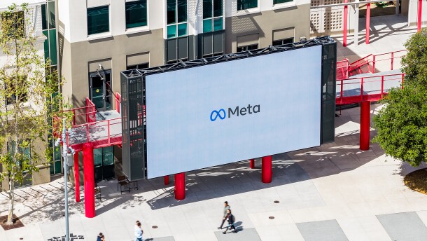 Workers walk past a display at Meta headquarters on Thursday, March 26, 2026, in Menlo Park, Calif.