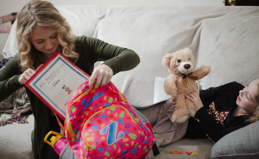 Allie Phillips, 28, discusses homework with her 6-year-old daughter, Adalie, at their home in Clarksville, Tenn.