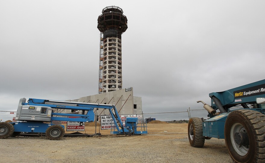 Construction equipment sits idle at the work site of a half-completed 236-foot FAA control tower at Oakland International Airport.