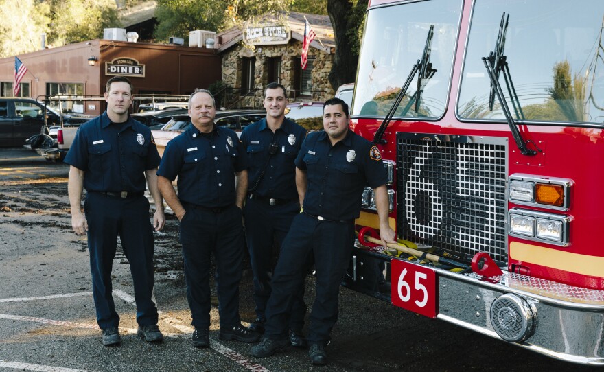 Los Angeles County firefighters, from left: Brian Knutson, Jay Colvin, Adam Young and Marcus Carballo. Knutson lives in the community and says this is the worst fire any of them can ever remember. "It's always hard to talk to someone that's lost their house," he says. "I wish we could have done more for them."