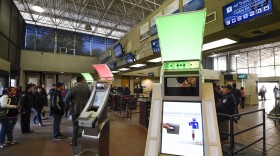 Pedestrians crossing from Mexico into the United States at the Otay Mesa Port of Entry wait to use biometric kiosks in San Diego., Dec. 10, 2015. 