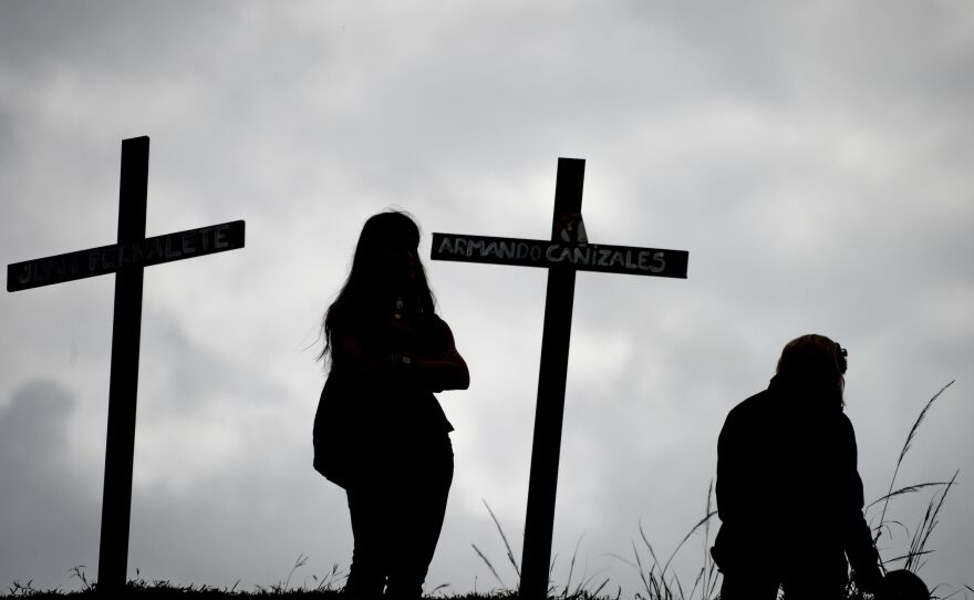 Venezuelan opposition activists set up crosses Monday in Caracas to commemorate those who have died in the protests against Maduro.