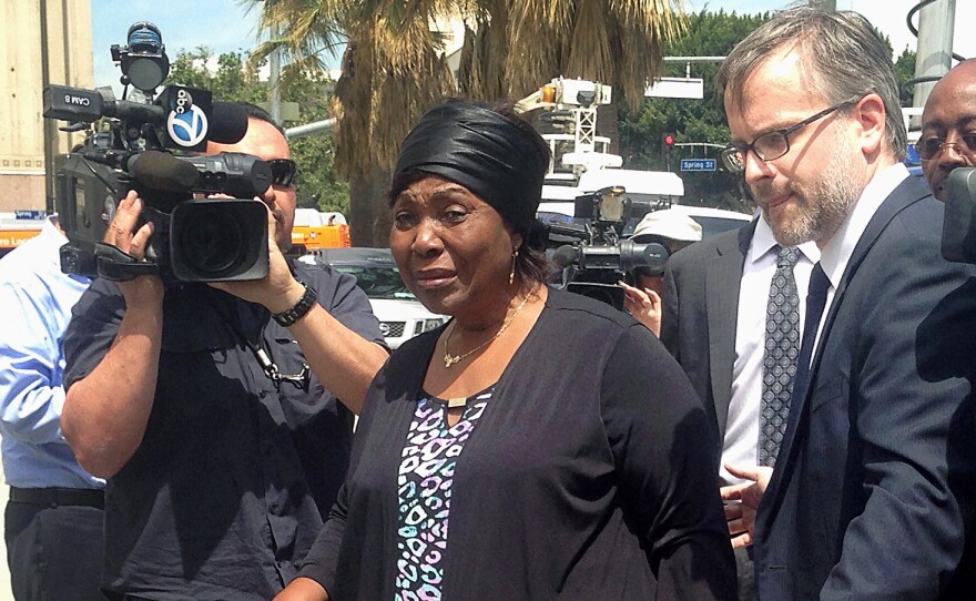 Heleine Tchayou, center, the mother of Charly Leundeu Keunang, a homeless man who was shot and killed during a confrontation on Skid Row by Los Angeles police, arrives at a news conference in Los Angeles in 2015. On Tuesday, the Los Angeles City Council approved a $1.9 million settlement with Keunang's family.