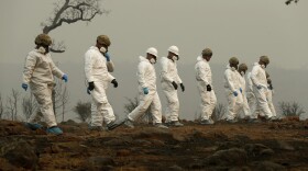 Members of the California Army National Guard search a property for human remains at the Camp fire, Wednesday, Nov. 14, 2018.