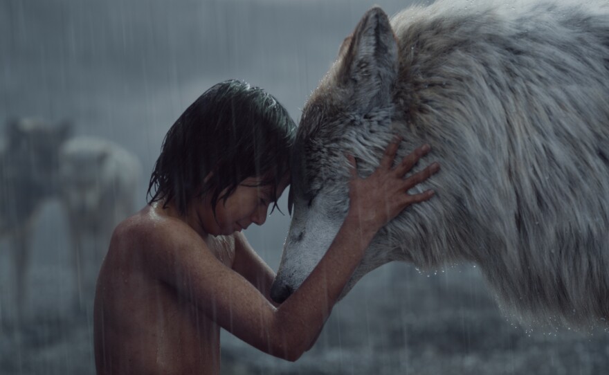 Mowgli has a moment with Raksha, the "mother wolf" who adopted him.
