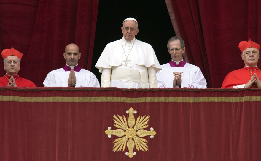 Pope Francis delivers his "Urbi et Orbi" (to the city and to the world) blessing from the central balcony of St. Peter's Basilica at the Vatican, on  Christmas Day.