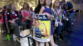 In this May 20, 2017 file photo, Christine Pelosi, holds her daughter Bella Pelosi Kaufman, 8, as she listens to her mother, U.S. Rep. Nancy Pelosi, address the California Democratic Party Convention in Sacramento, Calif. 