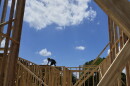 Workers work on the roofing structure of new home under construction, Tuesday, July 15, 2025, in Richardson, Texas.