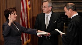 Chief Justice John Roberts administers the judicial oath to Elena Kagan at the Supreme Court Building in Washington on Saturday. The Bible is held by Jeffrey Minear, counselor to the chief justice.