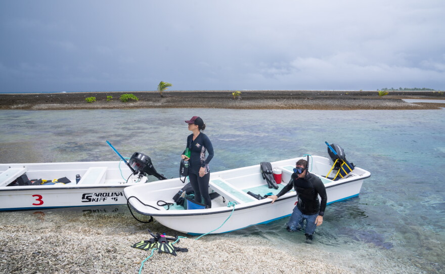 Katie Franklin (left) and Joe Pollock of The Nature Conservancy visit one of Palmyra Atoll's reefs. The islands themselves are made by the coral reefs, and their beaches are covered in large pieces of old coral.