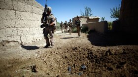 Marines on patrol in Afghanistan's Helmand province walk near a blast crater from a homemade  explosive device. Roadside bombs are the leading killer of U.S. troops in Iraq and Afghanistan. The American military has turned to mathematics and social network analysis to help identify bombers and their supporters.