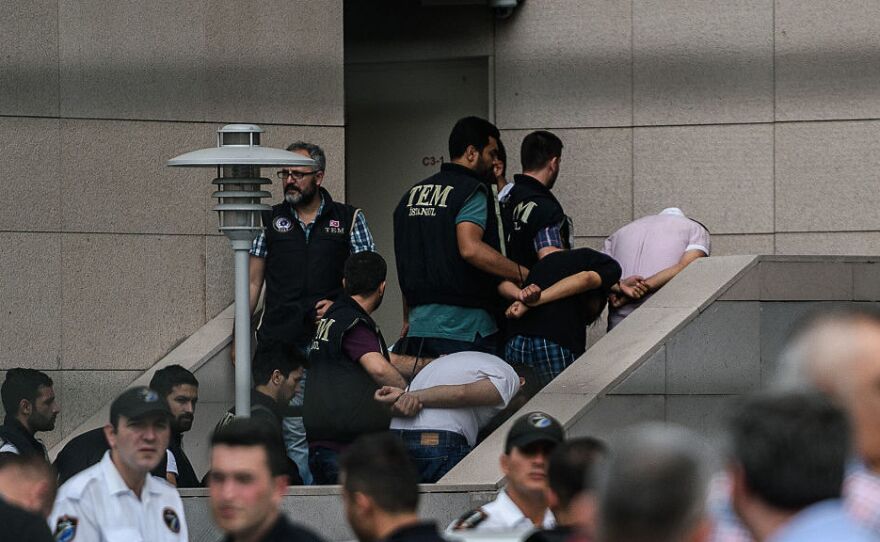 Detained Turkish soldiers who allegedly took part in a military coup arrive with their hands bound behind their backs at the Istanbul Justice Palace on Wednesday following the failed military coup attempt.