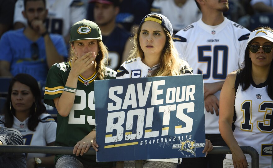 Football fans hold up a "Save Our Bolts" sign during an NFL football game between the San Diego Chargers and the Jacksonville Jaguars in San Diego, Sept. 18, 2016.