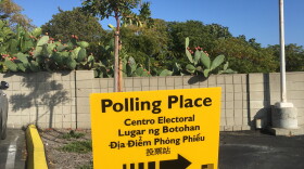 A polling place sign is shown in a parking lot in the San Diego neighborhood of San Carlos, Nov. 6, 2018. 