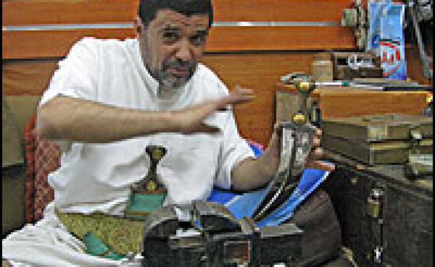 Knife-seller Abdullah al Azeri shows off a 300-year-old jambiya dagger that he says is worth more than $25,000. Azeri says his family has been in the knife business for more than 1,000 years.