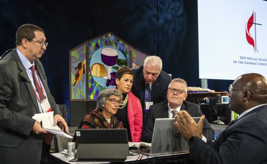 Leaders from the United Methodist Church confer during the 2019 Special Session of the General Conference of The United Methodist Church in St. Louis, Mo. America's second-largest Protestant denomination faces a likely fracture as delegates voted to strengthen bans on same-sex marriage and ordination of LGBT clergy.