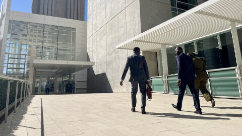 Attorney Wismick Saint-Jean walks into the United States Courthouse in downtown San Diego alongside his paralegal and Haitian Bridge Alliance co-founder Wister Gaetan, Oct, 16. 2026.
