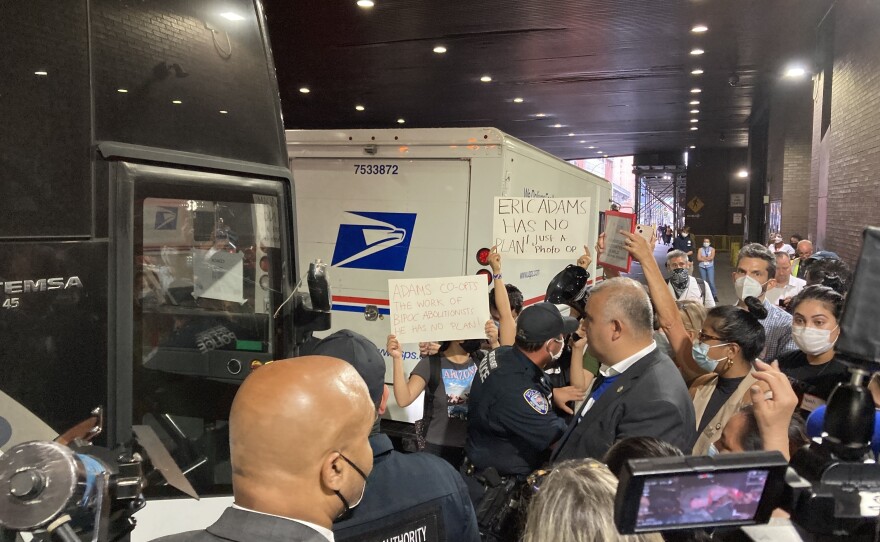 A crowd of New York City government officials, nonprofit workers, and activists greets a group of asylum-seekers arriving via bus from Texas on Aug. 10.