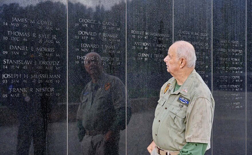 A veteran looks at The Vietnam Veterans Memorial. "A Place of Honor" recounts the lived experiences of veterans and gold star families from before, through and after the Vietnam War.