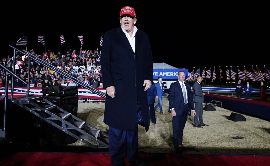 Former President Donald Trump smiles at the crowd after speaking at a rally on Jan. 15 in Florence, Ariz.
