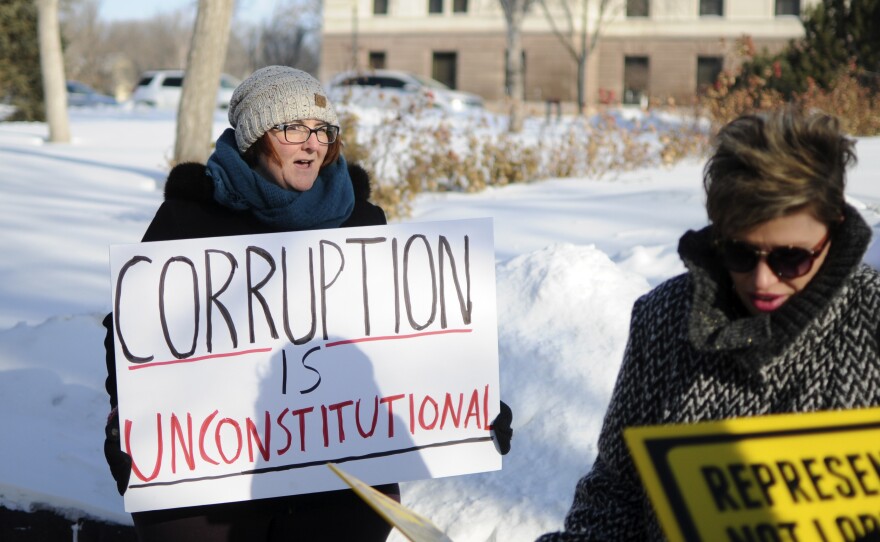 Roxanne Weber (left) rallies in support of a voter-approved government ethics overhaul in front of the South Dakota Capitol in Pierre last month. Republican Gov. Dennis Daugaard said he supports efforts to repeal and replace the initiative.