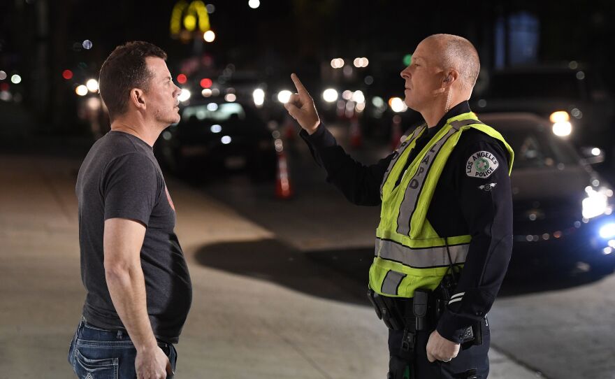 A man undergoes a sobriety test at a LAPD police DUI checkpoint in Reseda, Los Angeles, on April 13, 2018. A new federal law will eventually require new vehicles to detect and prevent drunk driving, which would revolutionize vehicle safety.