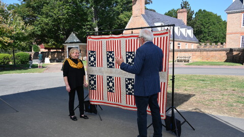 Wes Cowan (right) appraises a flag quilt, ca. 1880 in Williamsburg, Va. ANTIQUES ROADSHOW “250 Years of Americana” premieres Monday, April 20 at 8/7C PM on PBS.
