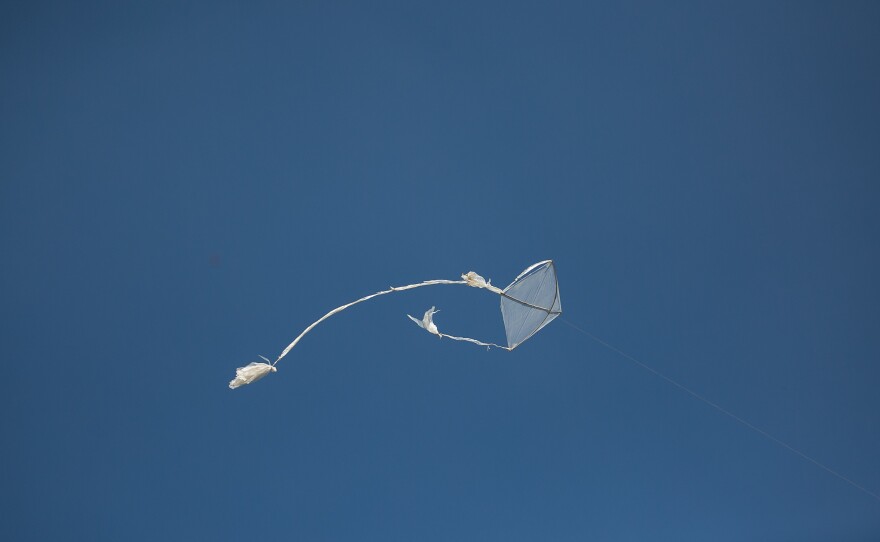 One of Khamal's kites flies over the camp.